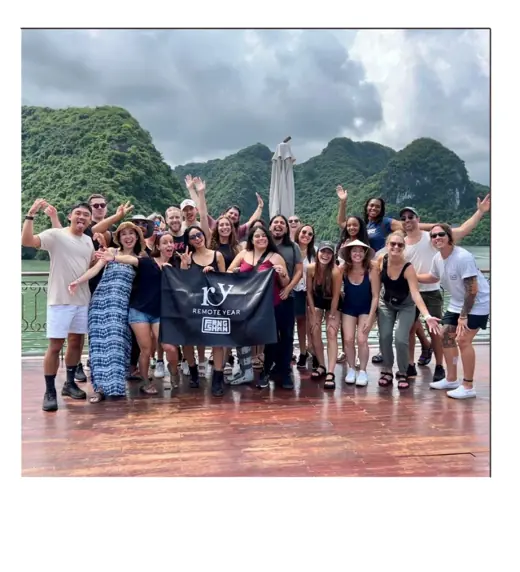 Matt with the Remote Year group in front of green mountains