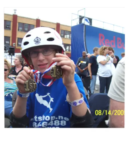 Matt holding two first-place skateboarding medals as a teenager